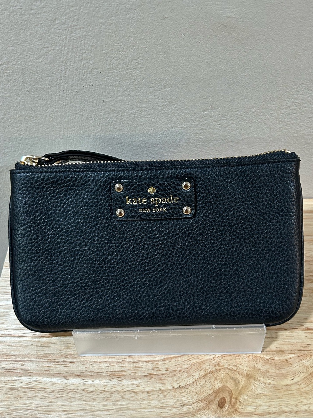 kate spade black pebbled leather wristlet with gold-tone logo